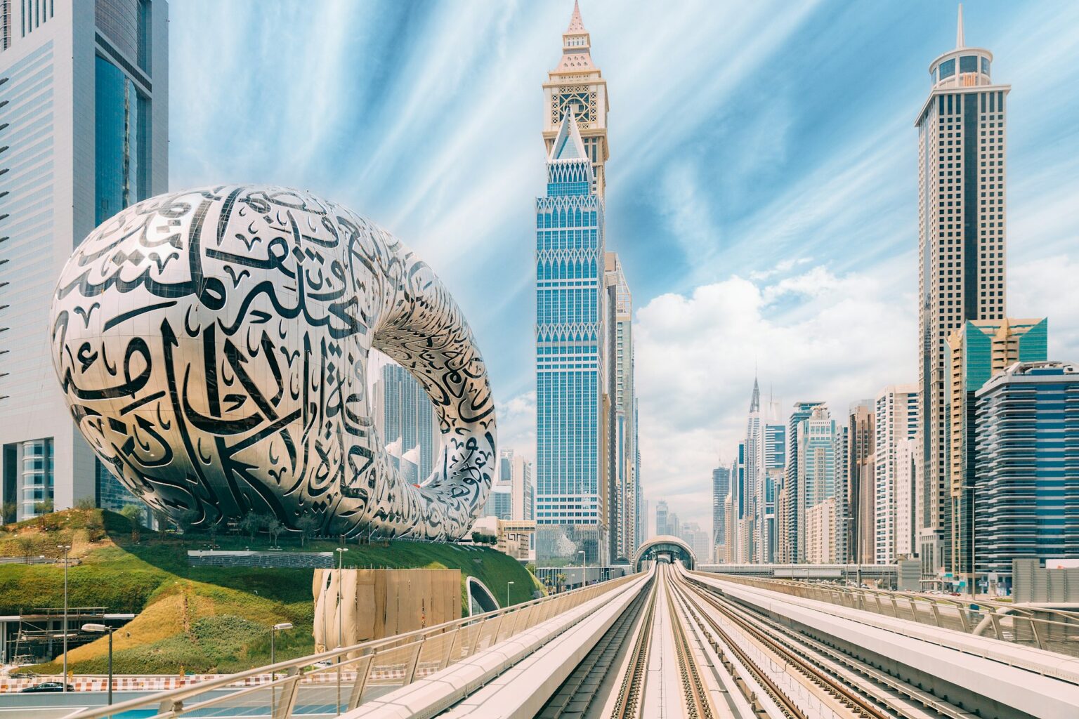 Metro railway among among glass skyscrapers in Dubai. Traffic on street in Dubai.